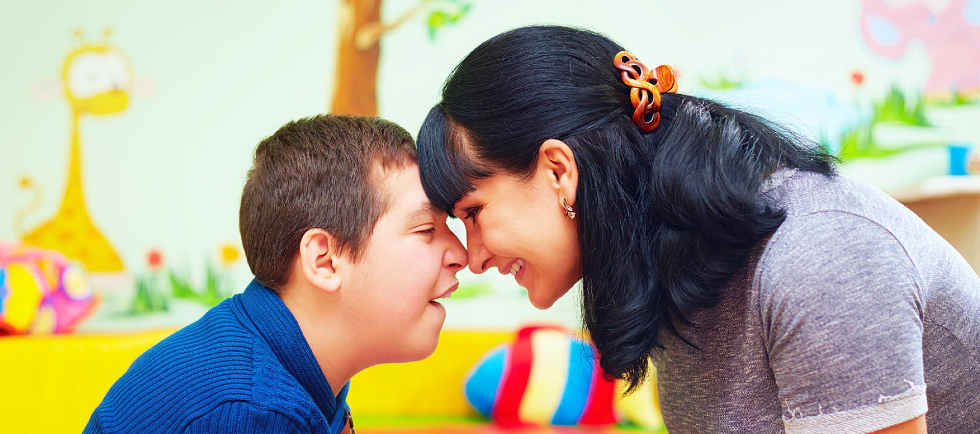 a boy and his mother smiling at each other