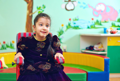 little girl sitting in wheelchair 